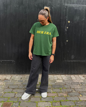 Kyah Simon wearing the front of the green Her Era Statement by KS Label