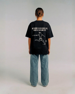 Model wearing the back of the black SHE CAN Tee by KS Label