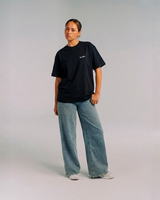Model wearing Her Era Oversized Black Tee by KS Label