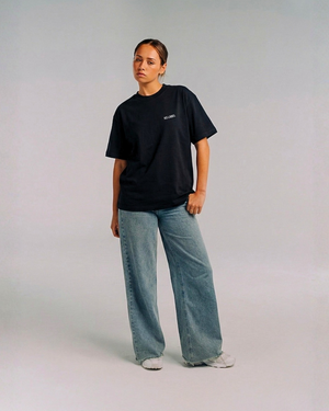 Model wearing Her Era Oversized Black Tee by KS Label