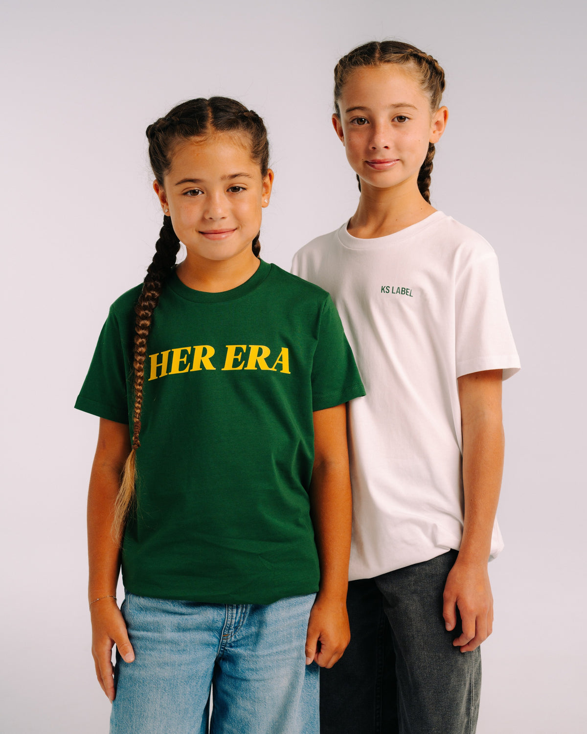 Her Era Statement Youth tee in Core Green, worn in studio, front view – KS Label