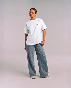 Model wearing the front of the white SHE CAN Tee by KS Label