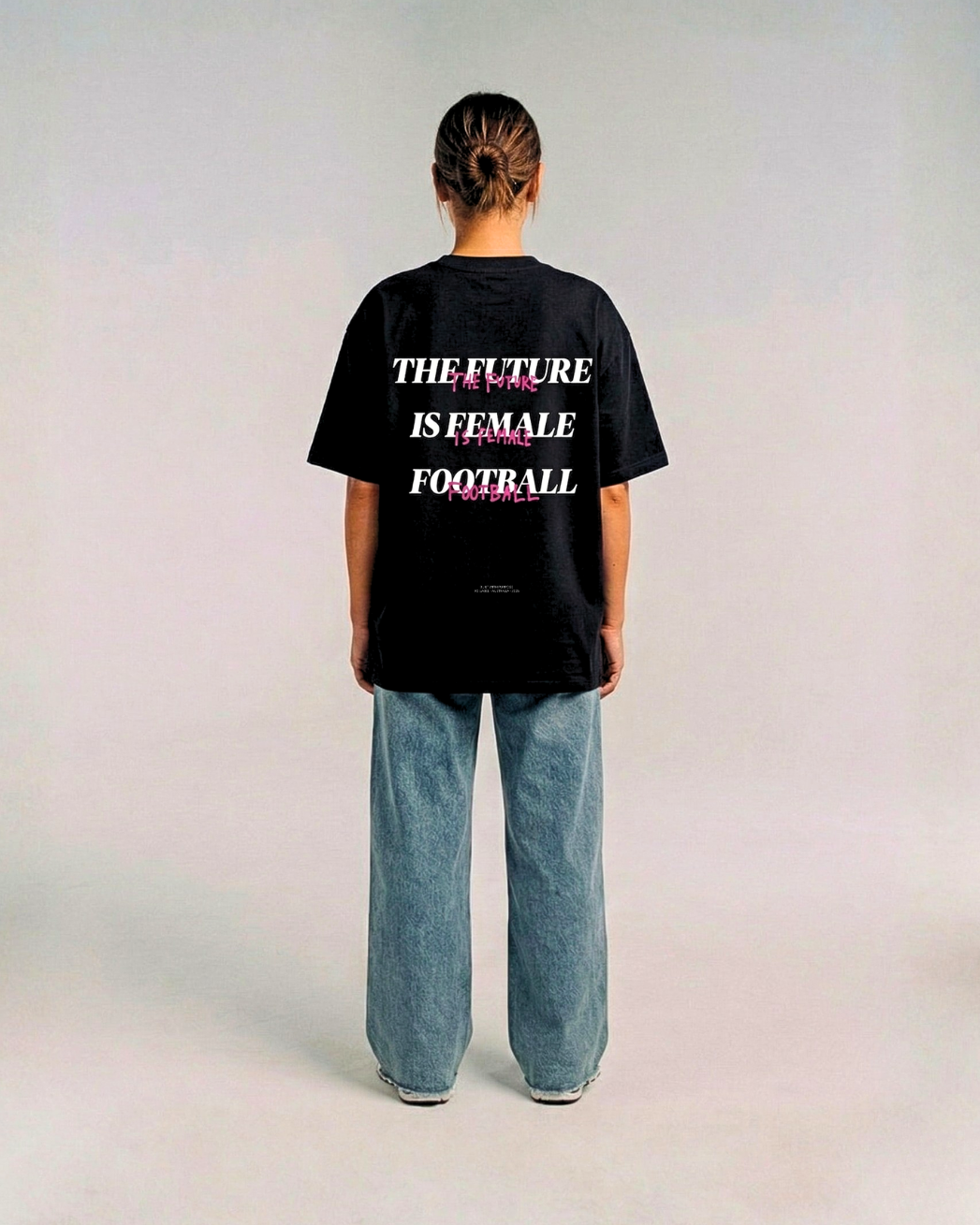 Model wearing the back of the black HER ERA OVERSIZED tee by KS Label