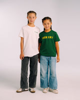 Two models wearing the white and green Her Era Statement Youth tees by KS Label