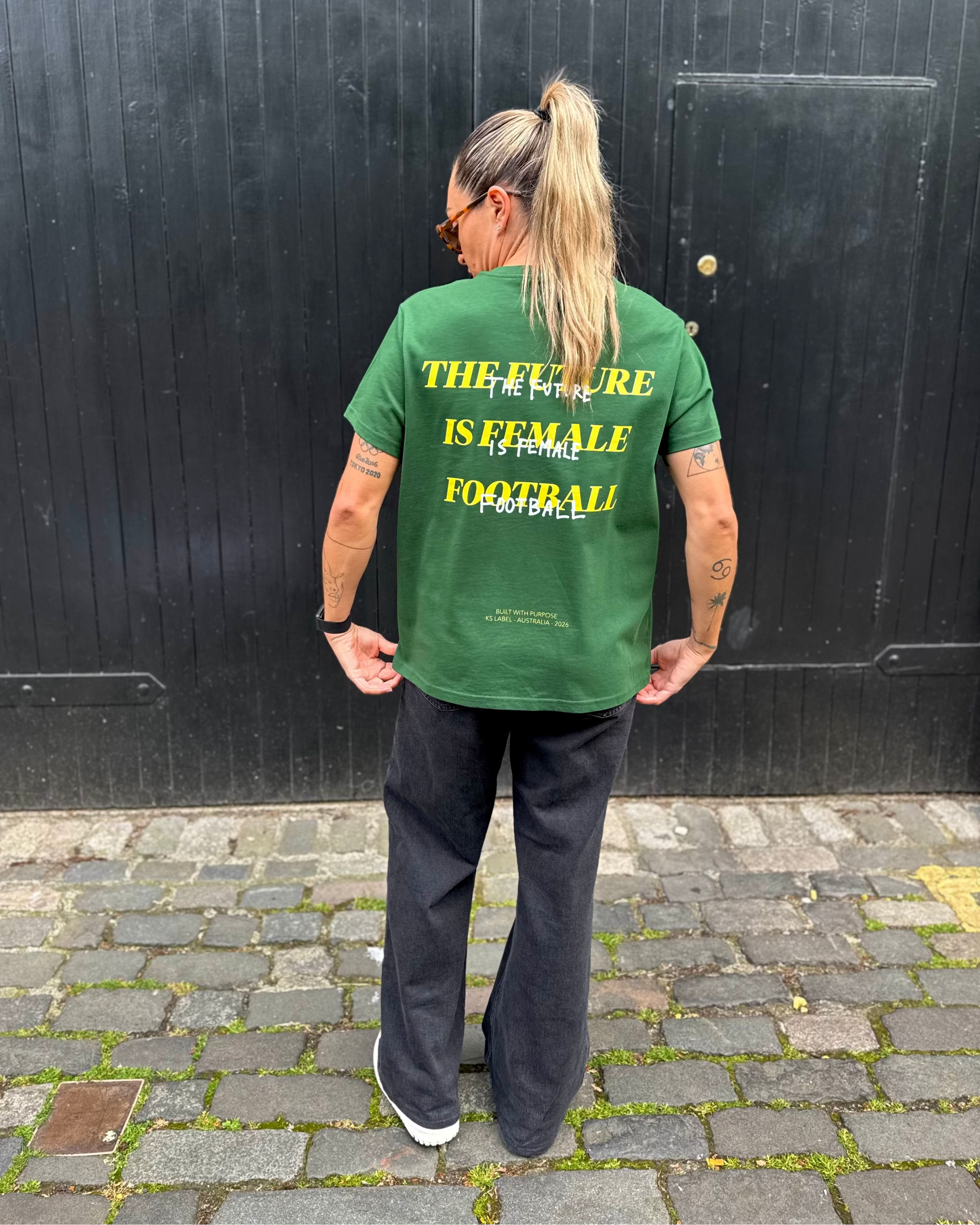 Kyah Simon wearing the back of the green Her Era Statement by KS Label