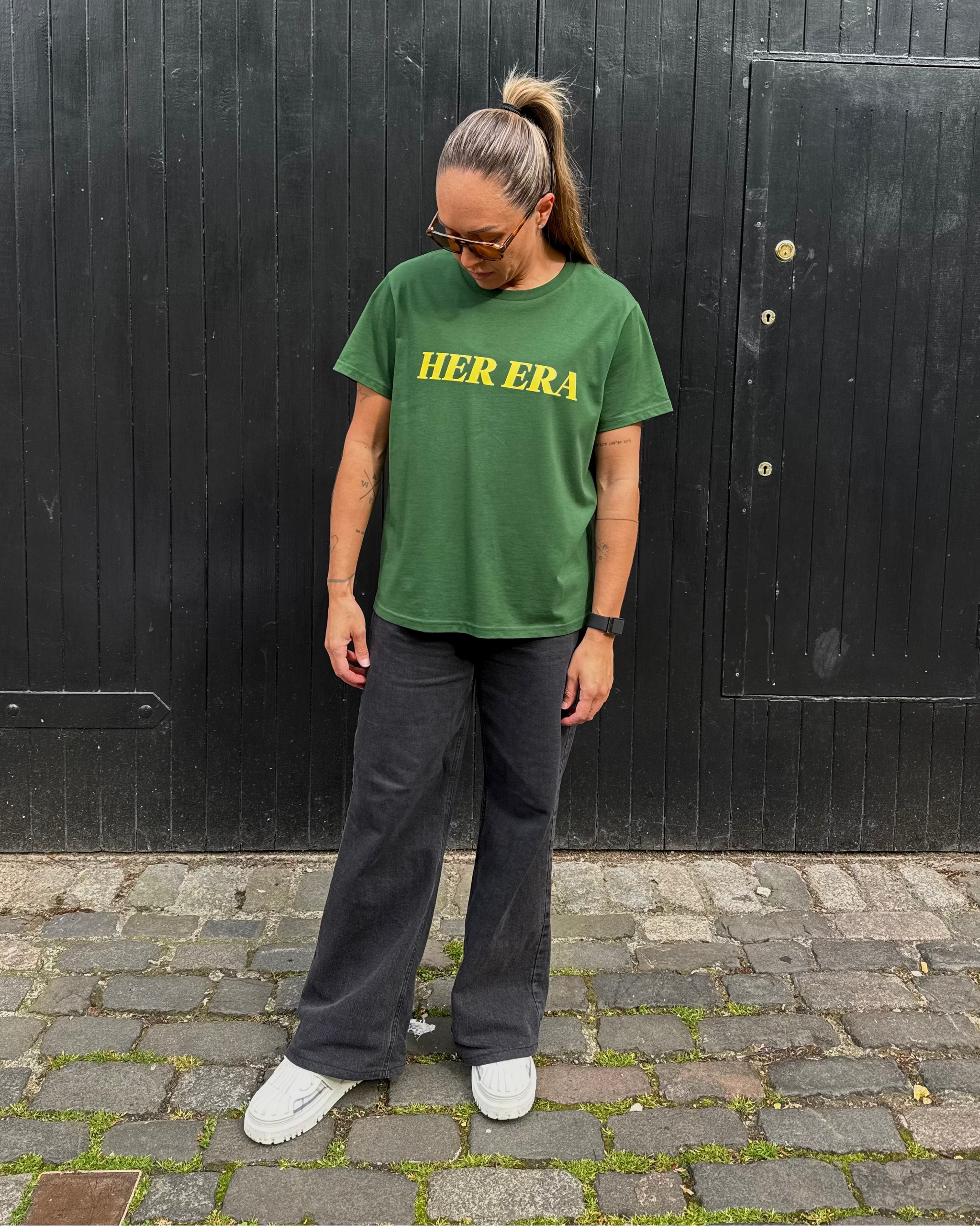 Kyah Simon wearing the front of the green Her Era Statement by KS Label