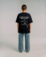 Model wearing the back of the black SHE CAN Tee by KS Label