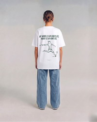 Model wearing the back of the white SHE CAN Tee by KS Label